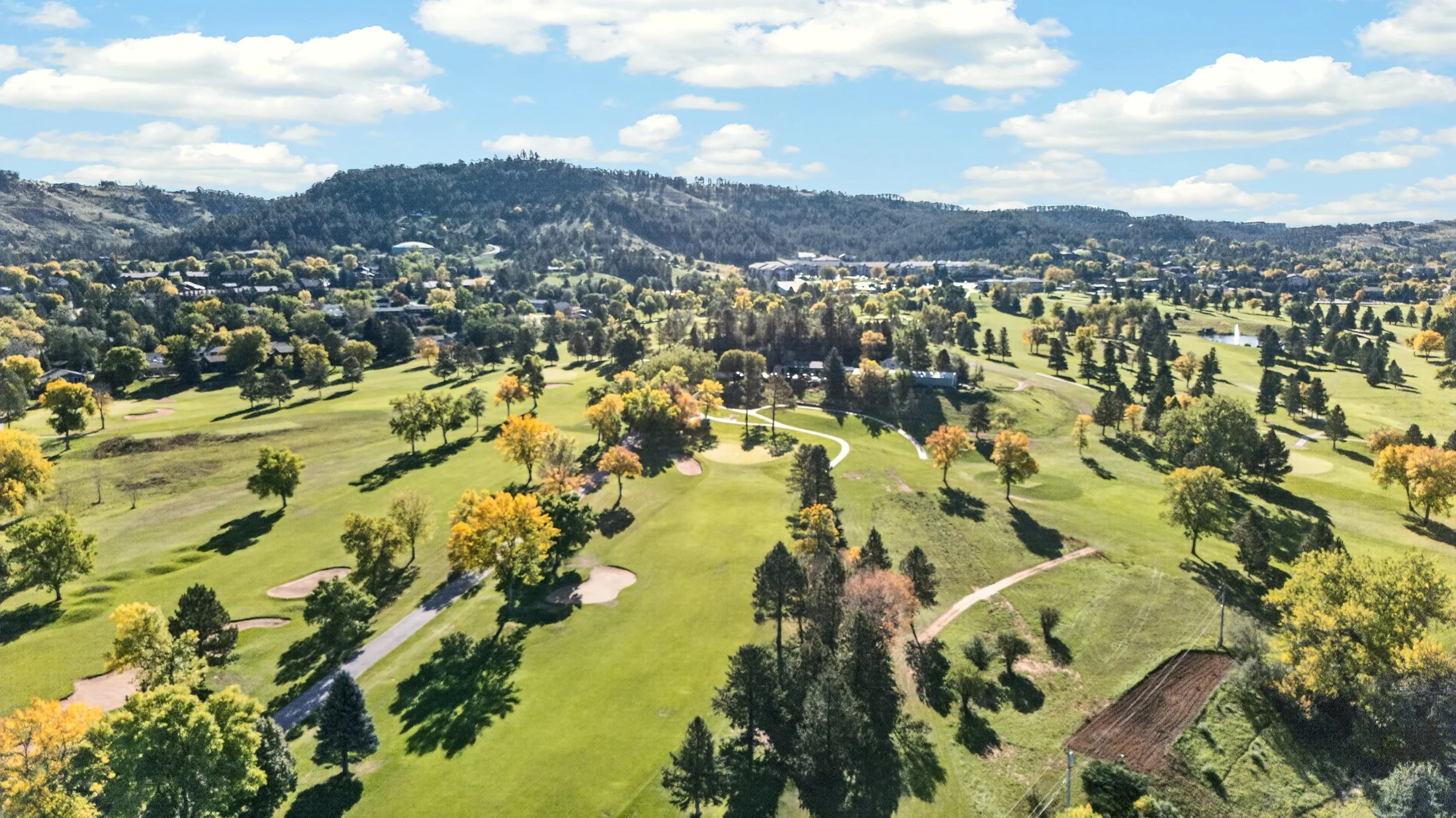 Aerial view across Arrowhead Country Club and the surrounding Sheridan Lake Road area in Rapid City, South Dakota, photographed by Henry Roy.