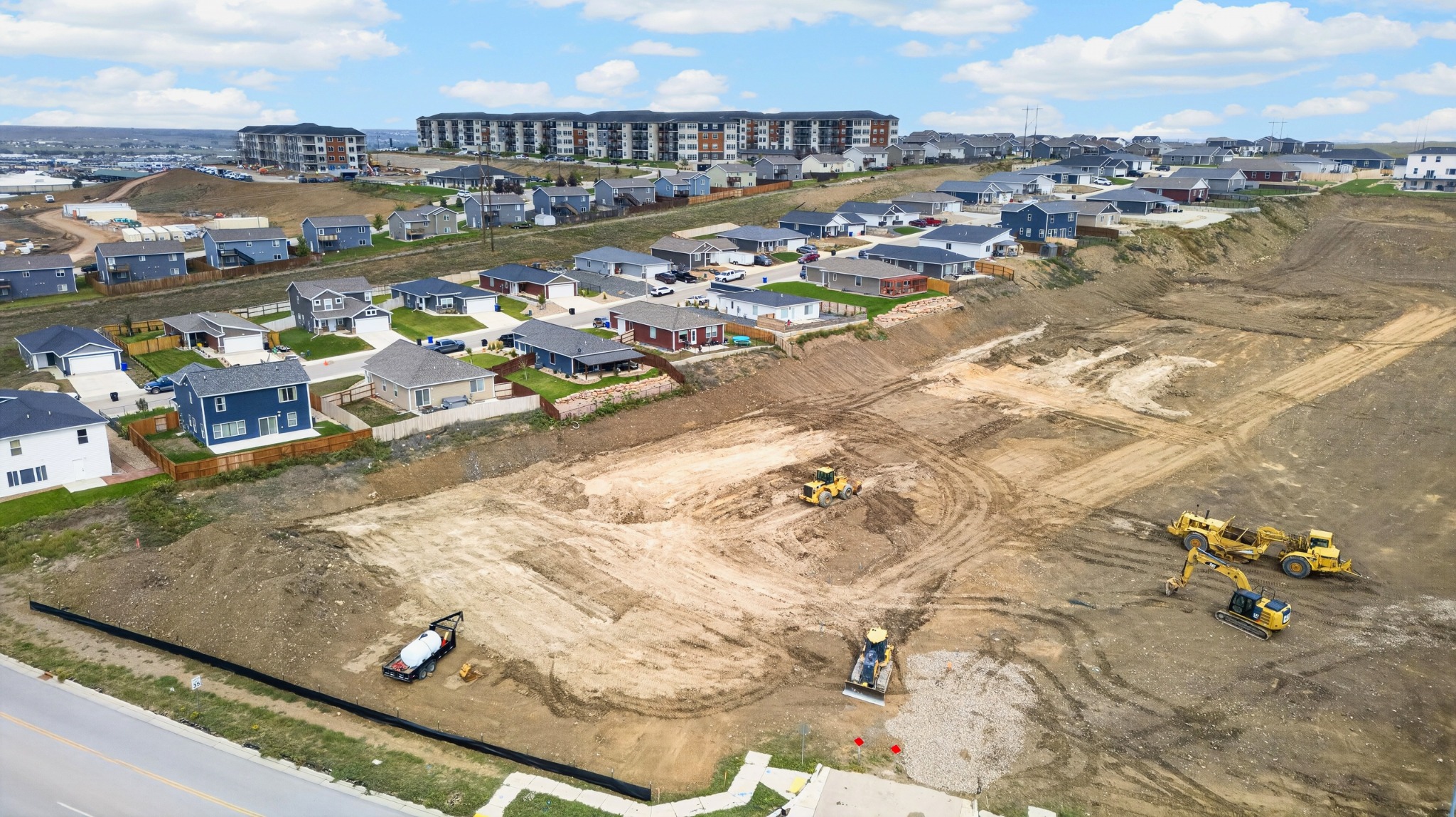 Aerial view of homes and nearby development around Shepherd Hills in Rapid City, South Dakota, photographed by Henry Roy.