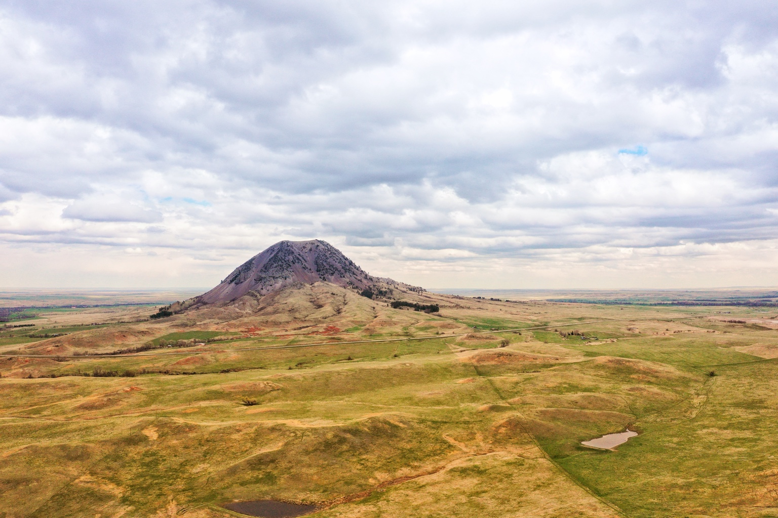 Bear Butte rising above the open prairie near Sturgis