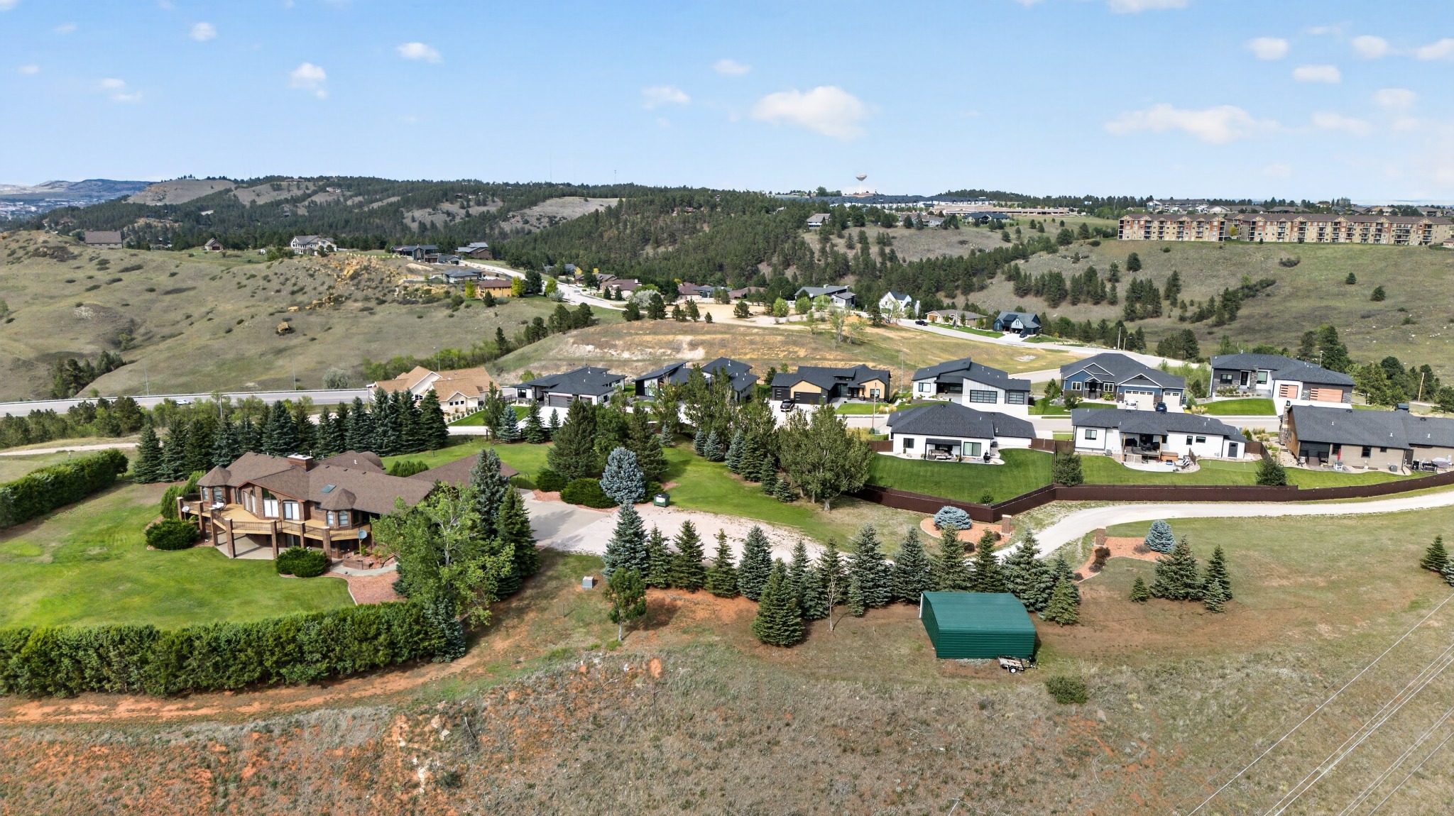 Row of newer homes along Covenant Drive in Bella Vista Estates with the hills behind